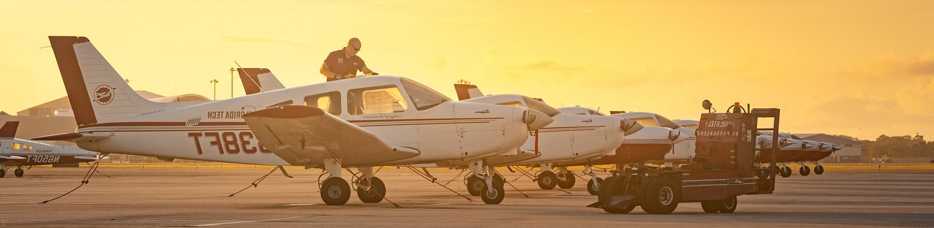 A man inspecting a plane in the Florida Tech fleet