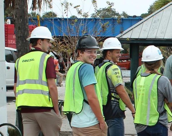 Students on a field trip to a bridge-building construction site